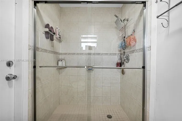 a bathroom with a window and a shower