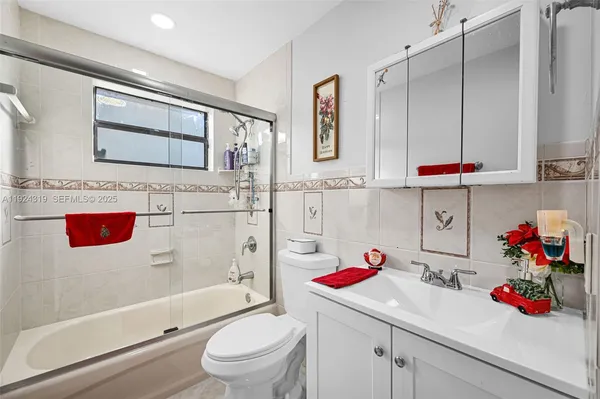 a bathroom with a sink a vanity and a toilet