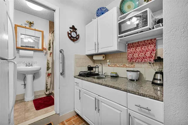 a kitchen with stainless steel appliances granite countertop a sink dishwasher stove and cabinets