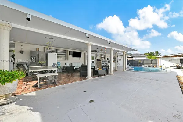 a view of a room with gym equipment and potted plants
