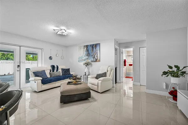 a living room with furniture and a chandelier