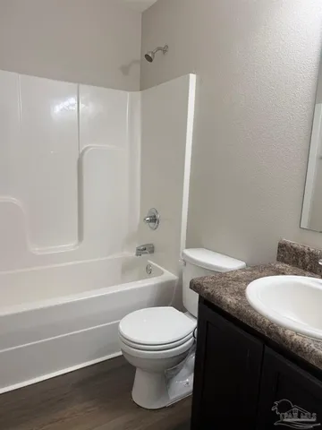 a bathroom with a toilet a sink and bathtub