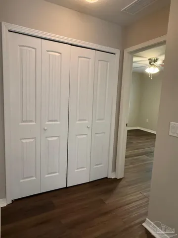 a view of a room with wooden floor