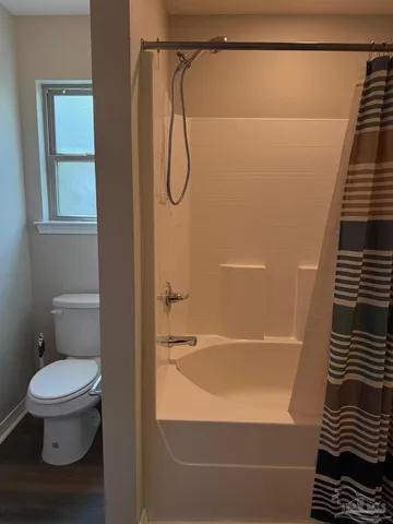 a bathroom with a toilet and a shower