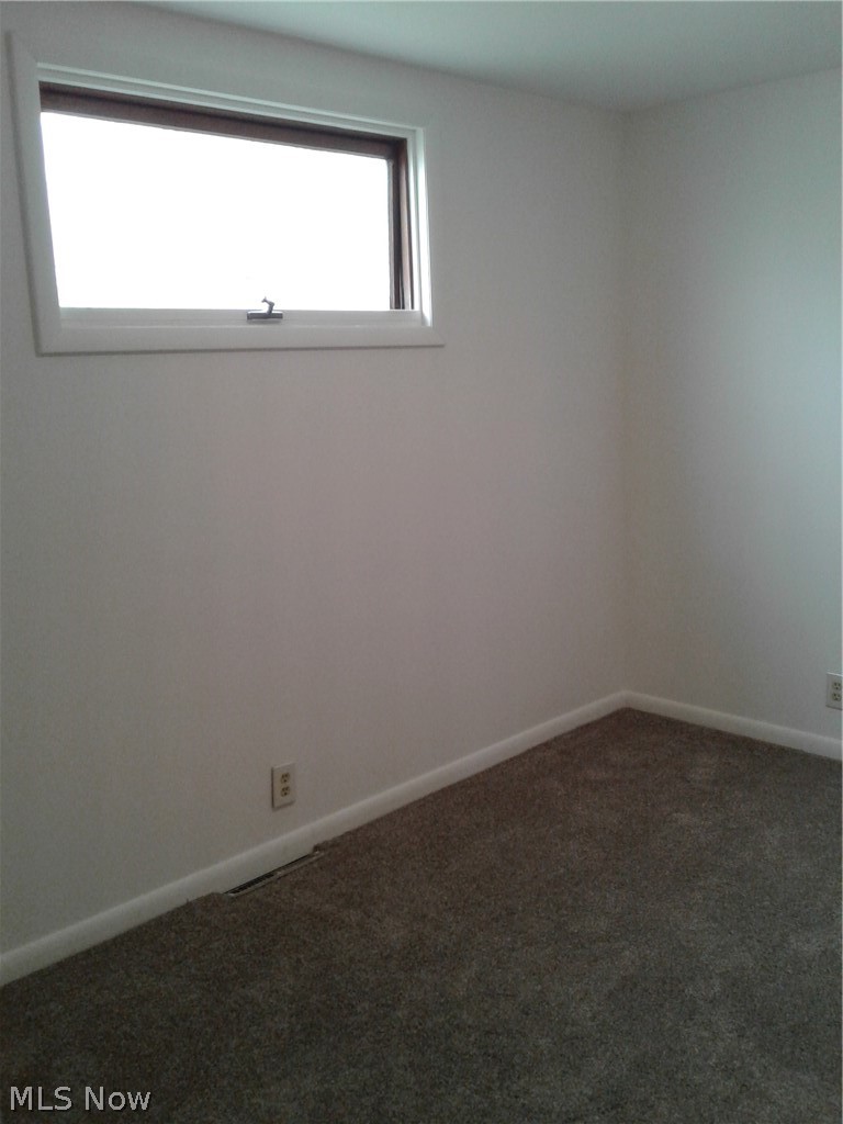 613 Jackson Street Amherst, OH 44001 - Photo 19 of 29 Guest Bedroom with baseboards and new carpet