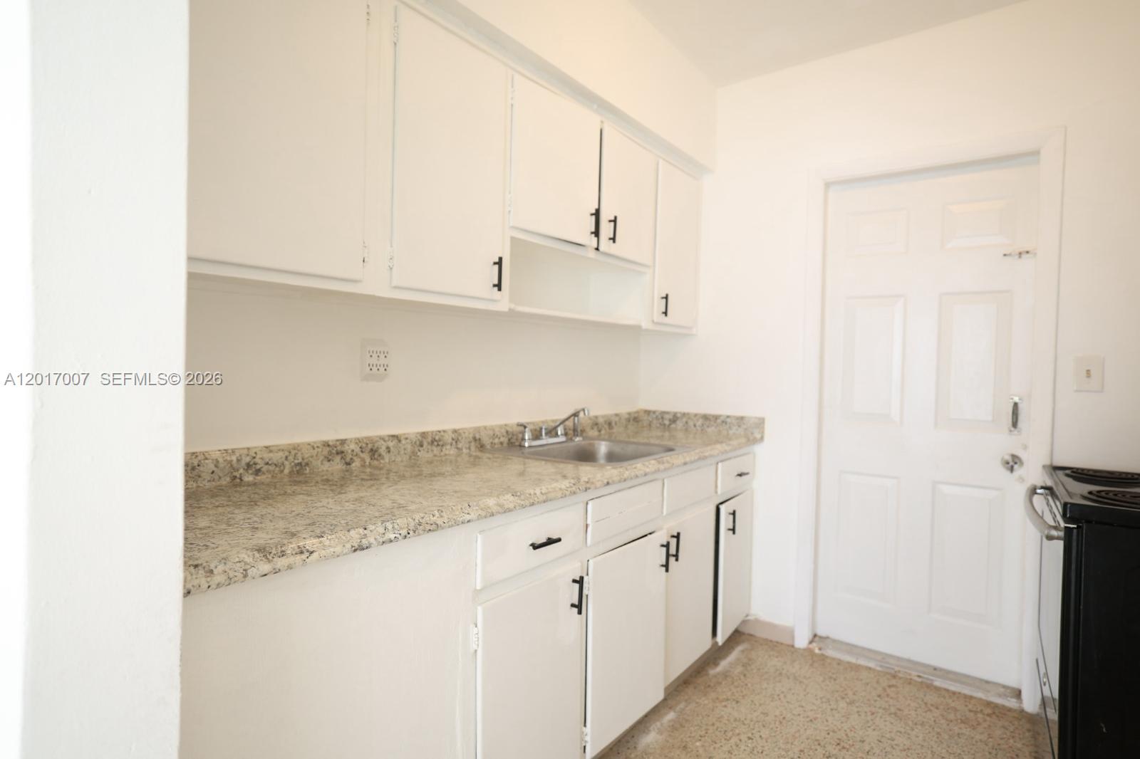 800 83rd Street, Unit 2 Miami Beach, FL 33141 - Photo 1 of 10 a kitchen with a sink cabinets and appliances