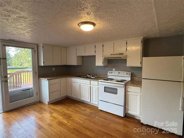 a kitchen with a white cabinets and white appliances