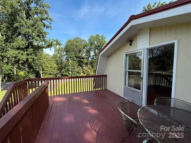 a view of a balcony with floor to ceiling window and wooden floor
