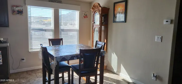 a view of a dining room with furniture and window