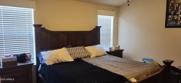 a bedroom with a bed and a window