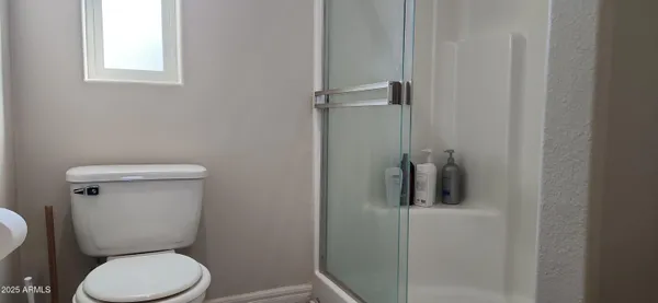 a white toilet sitting next to a bathroom sink