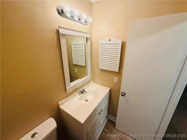 a bathroom with a sink toilet and mirror