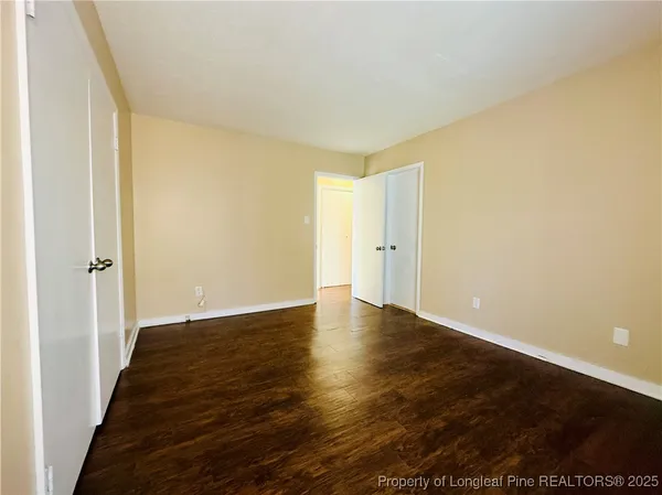 a view of an empty room and wooden floor