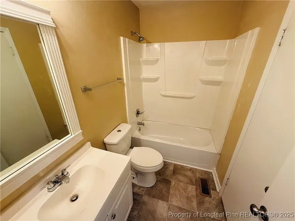 a bathroom with a sink a toilet and shower curtain