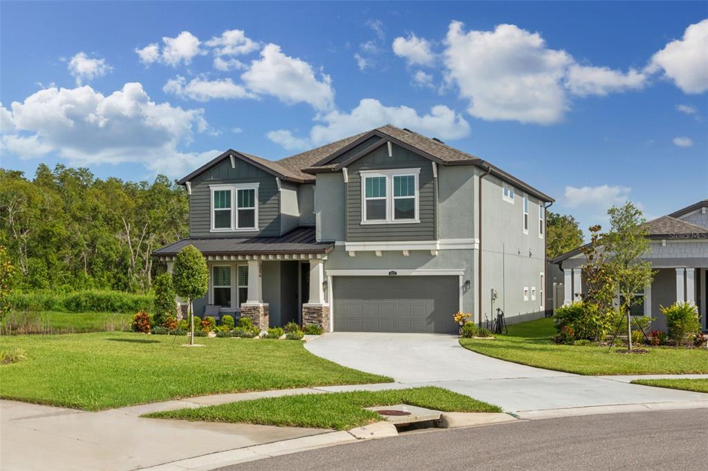 a front view of a house with a yard and garage