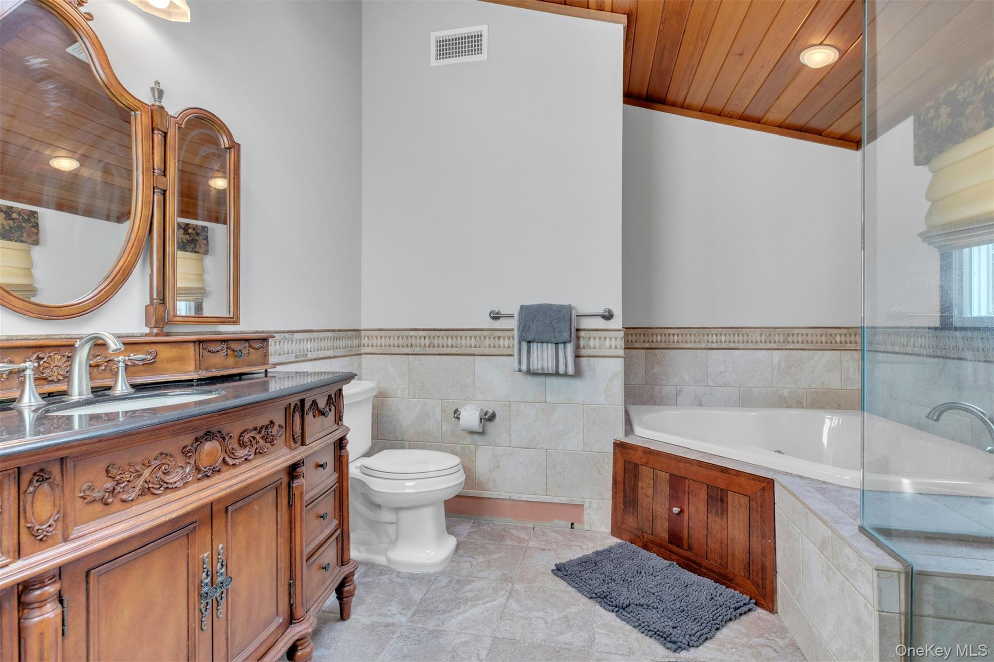 345 Colonial Road Southold, NY 11971 - Photo 23 of 43 a bathroom with a sink a toilet and a mirror