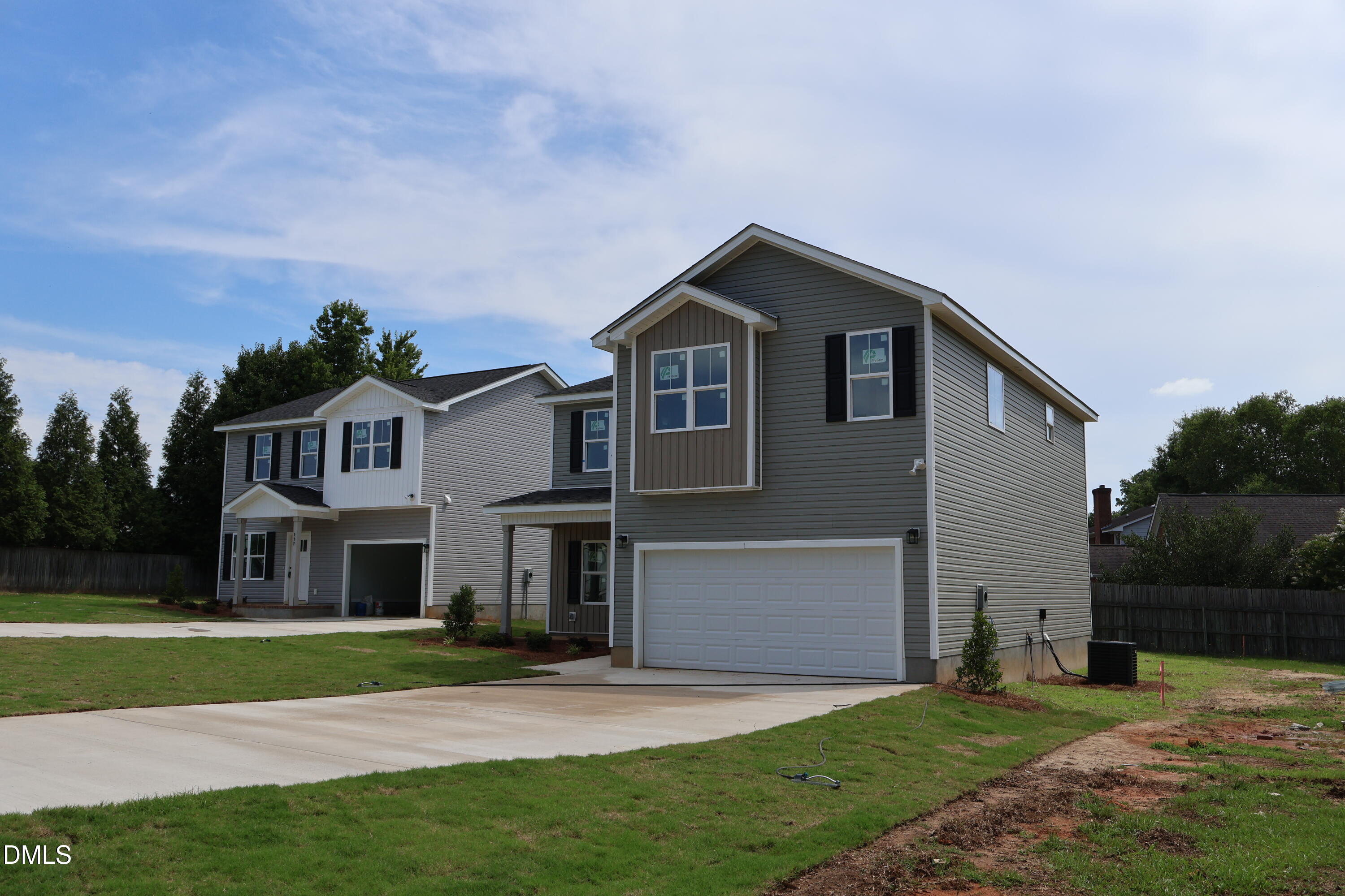 125 Wilson Street Erwin, NC 28339 - Photo 2 of 22 a front view of a house with a yard and garage