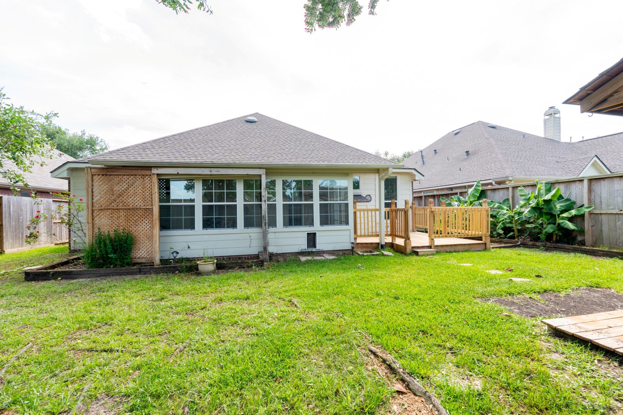 10619 Crownsedge Drive Spring, TX 77379 - Photo 37 of 38 This is a cozy, single-story home with a well-maintained backyard and a wooden deck. The exterior features large windows and a privacy fence, offering a perfect space for relaxation and outdoor activities.