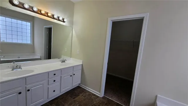 a bathroom with a double vanity sink and mirror