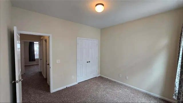 an empty room with closet area