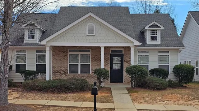 a front view of a house with garden