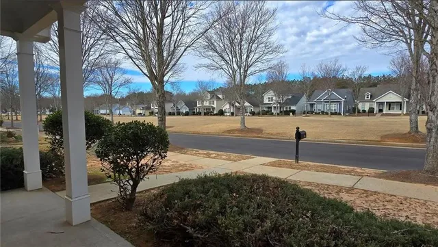 a front view of a house with garden covered with snow