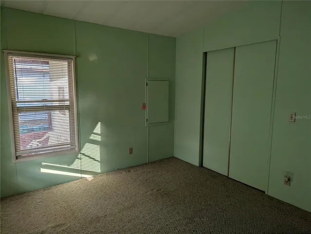 a view of empty room with window and fireplace