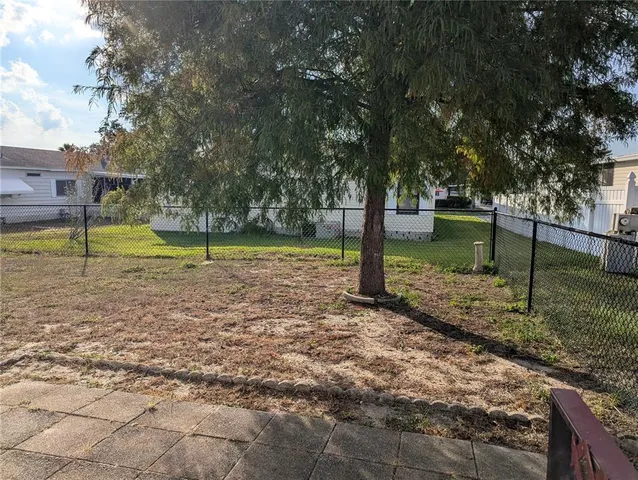 a view of a yard with a tree