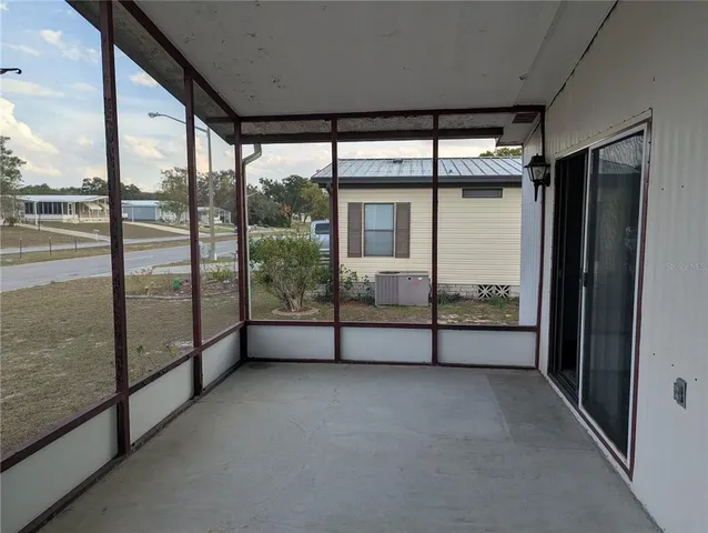 a view of a porch with a floor to ceiling window