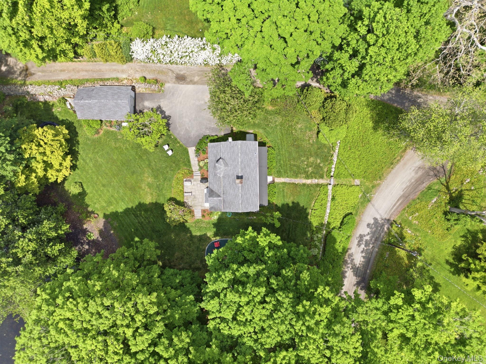 23 Pound Ridge Road Pound Ridge, NY 10576 - Photo 33 of 40 an aerial view of a house with a yard and garden