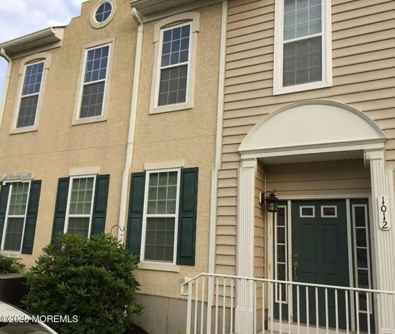 a view of a brick house with large windows