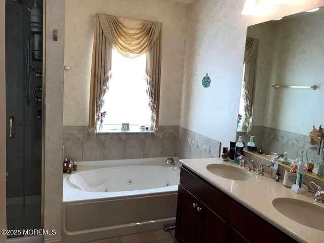 a bathroom with a bathtub and a sink