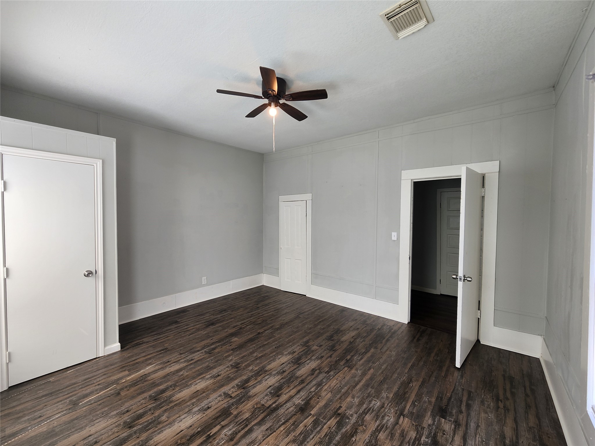 506 9th Street Hempstead, TX 77445 - Photo 13 of 23 an empty room with wooden floor closet and windows