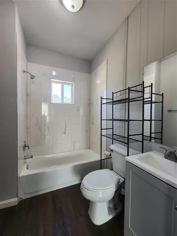 a bathroom with a toilet a sink and bathtub