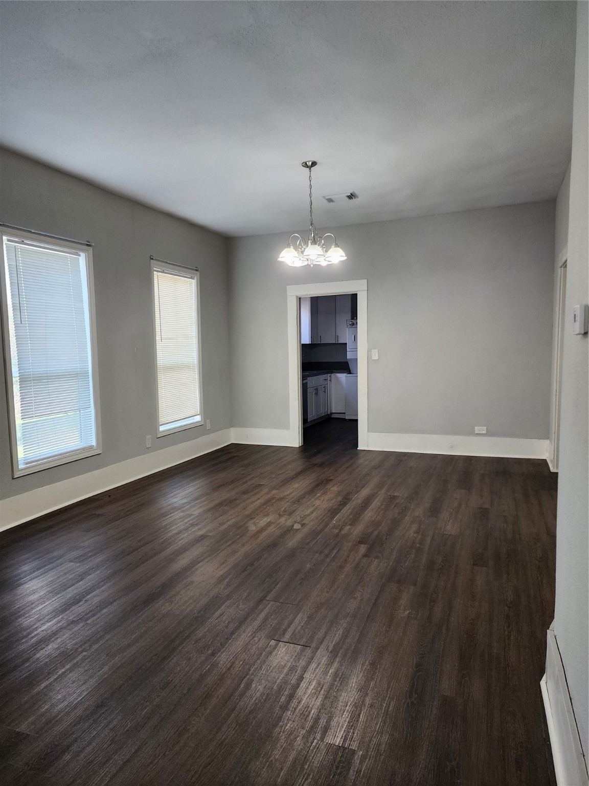 506 9th Street Hempstead, TX 77445 - Photo 16 of 23 an empty room with wooden floor and windows