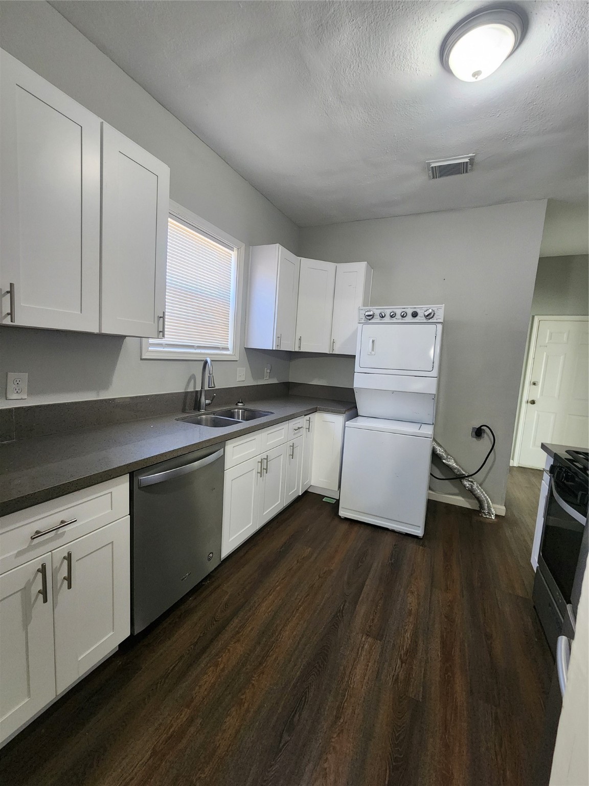 506 9th Street Hempstead, TX 77445 - Photo 19 of 23 a kitchen with sink cabinets and wooden floor