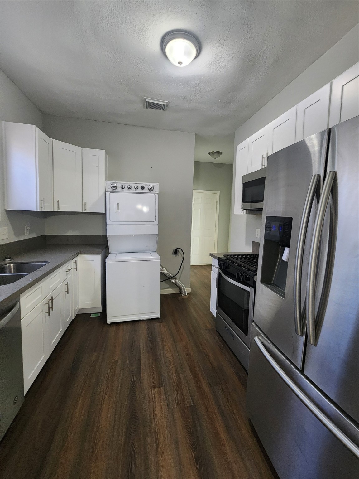 506 9th Street Hempstead, TX 77445 - Photo 20 of 23 a kitchen with a refrigerator and a sink
