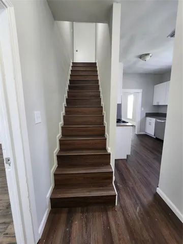 a view of entryway and hall with wooden floor