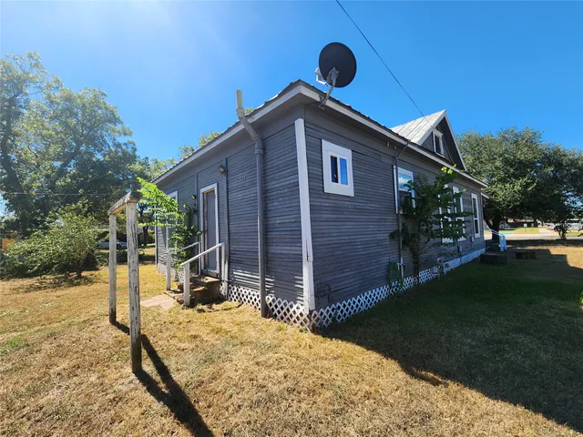 a backyard of a house with barbeque oven