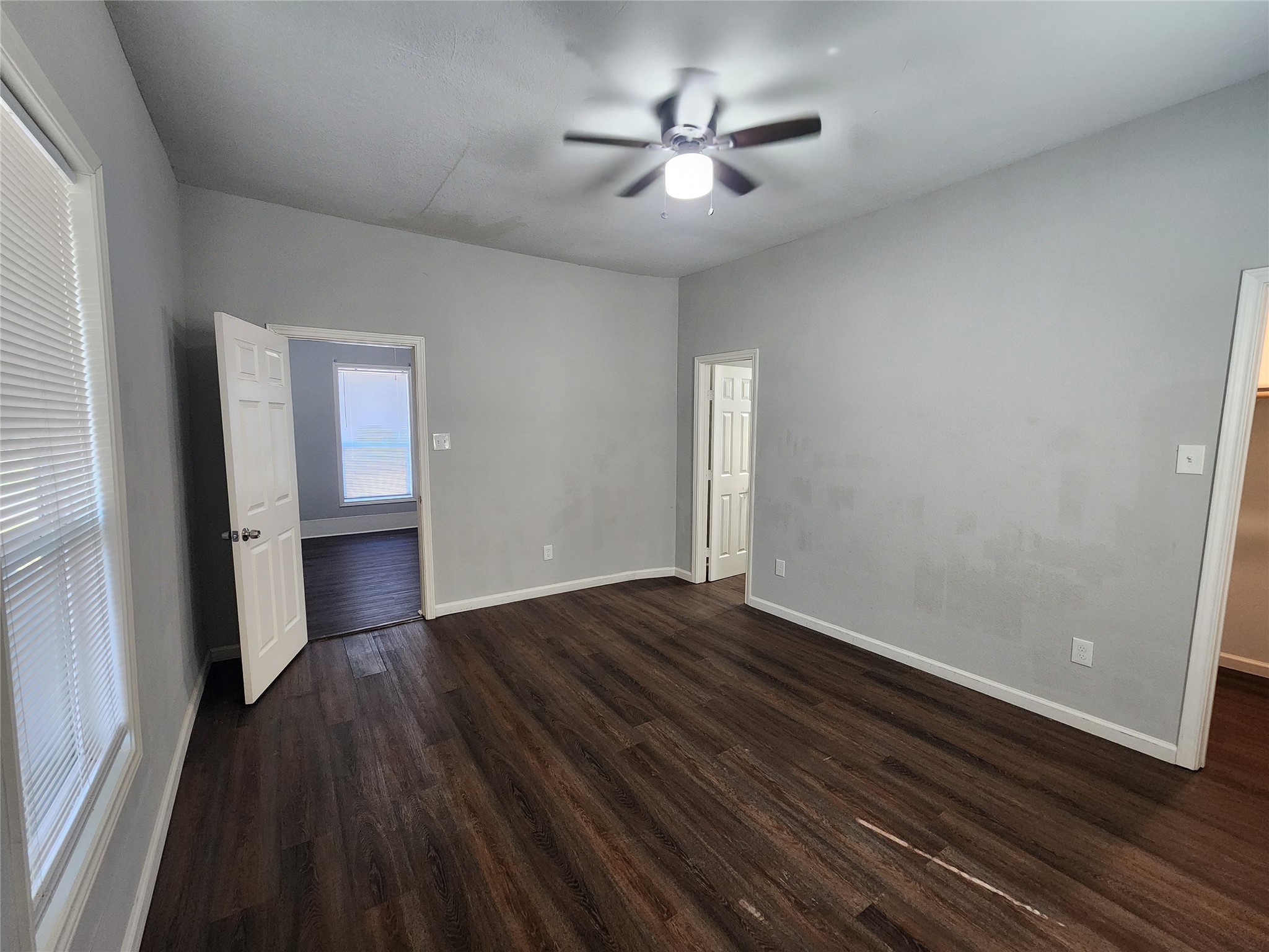 506 9th Street Hempstead, TX 77445 - Photo 8 of 23 a view of empty room with wooden floor and fan
