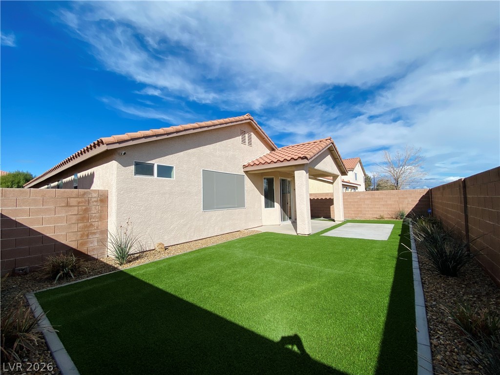 8794 Timber Mesa Street Las Vegas, NV 89139 - Photo 10 of 26 This private yard features low-maintenance turf and a welcoming covered patio.