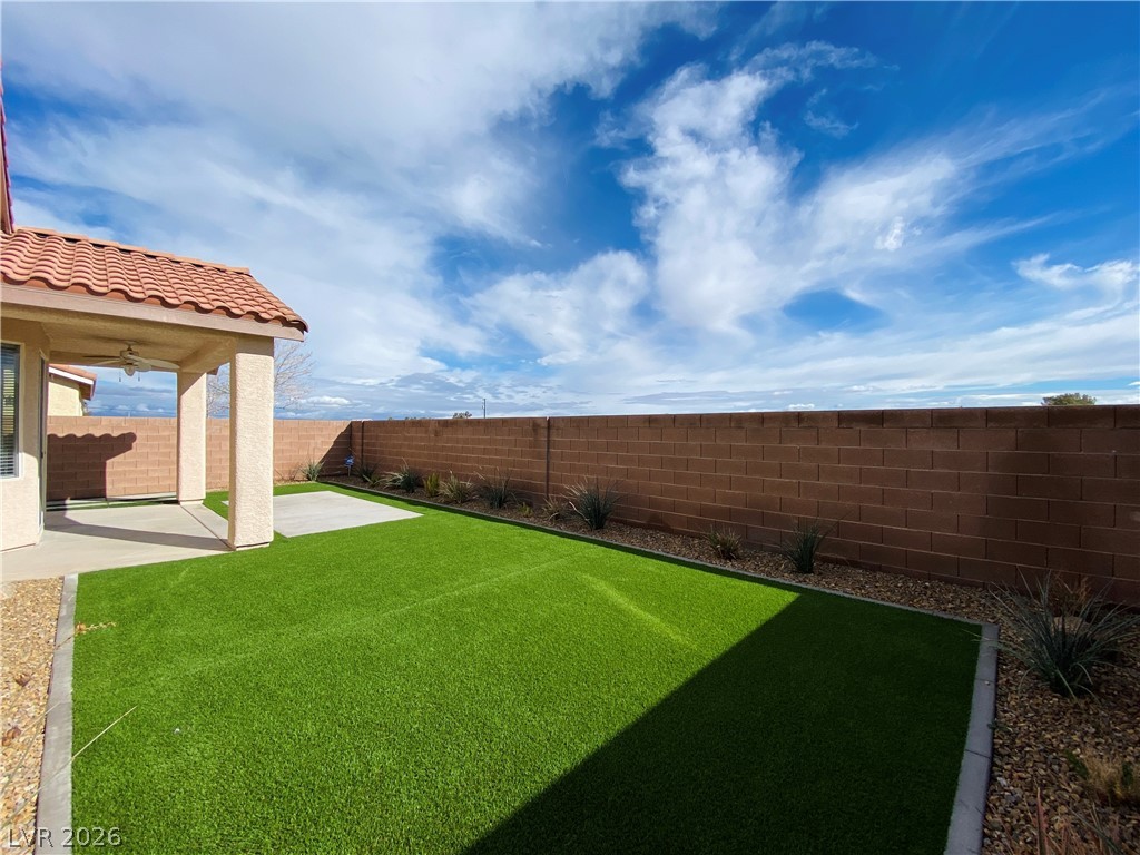 8794 Timber Mesa Street Las Vegas, NV 89139 - Photo 12 of 26 This private yard offers a spacious patio area and low-maintenance artificial turf.