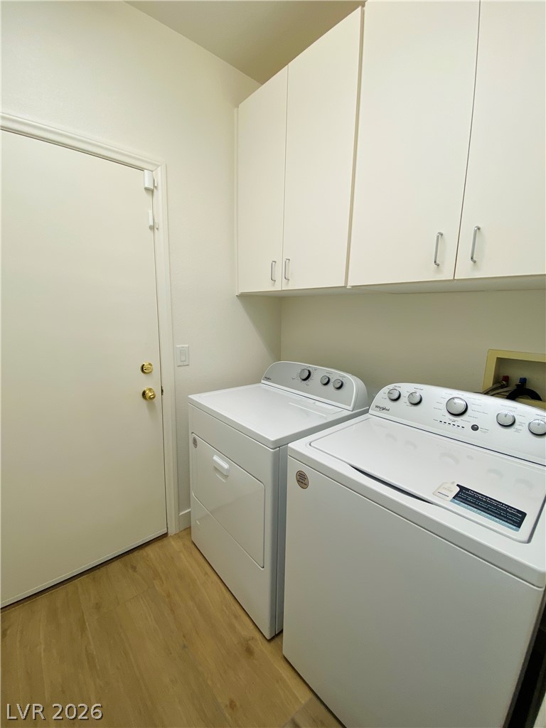 8794 Timber Mesa Street Las Vegas, NV 89139 - Photo 13 of 26 This dedicated space offers convenience with ample storage and essential laundry facilities.