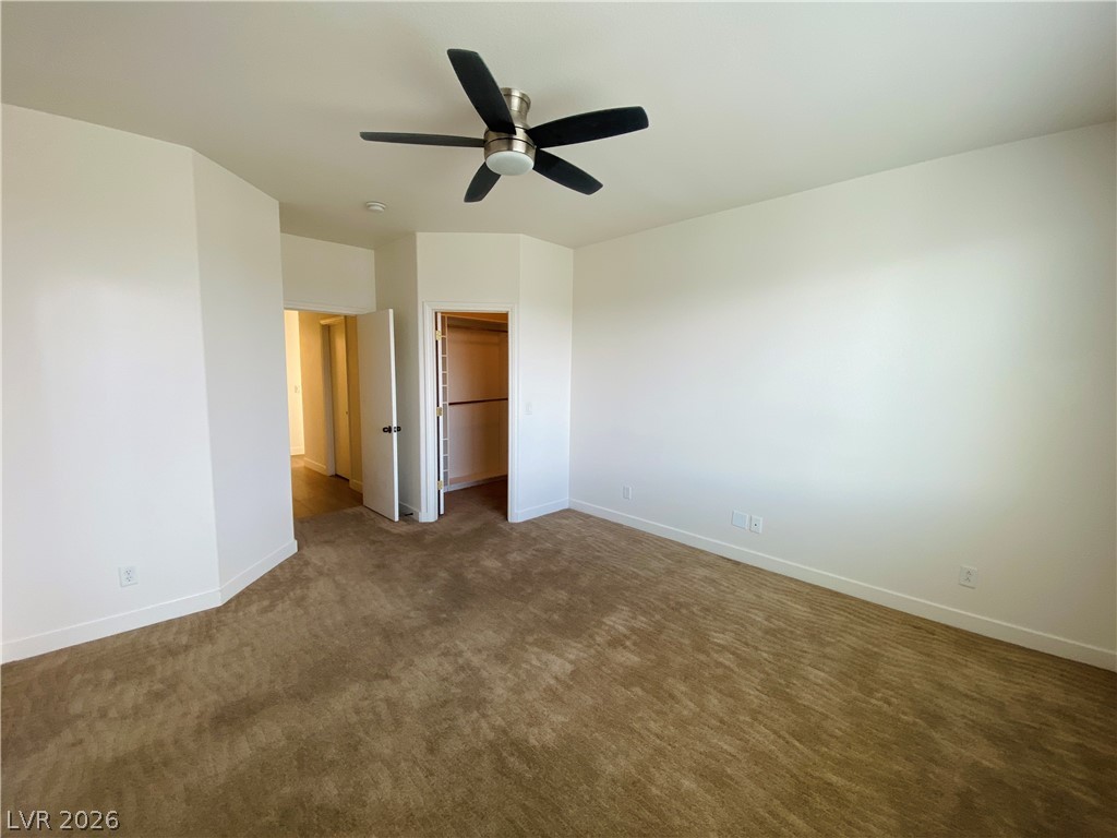 8794 Timber Mesa Street Las Vegas, NV 89139 - Photo 15 of 26 This spacious bedroom offers ample comfort and convenience, perfect for relaxation.