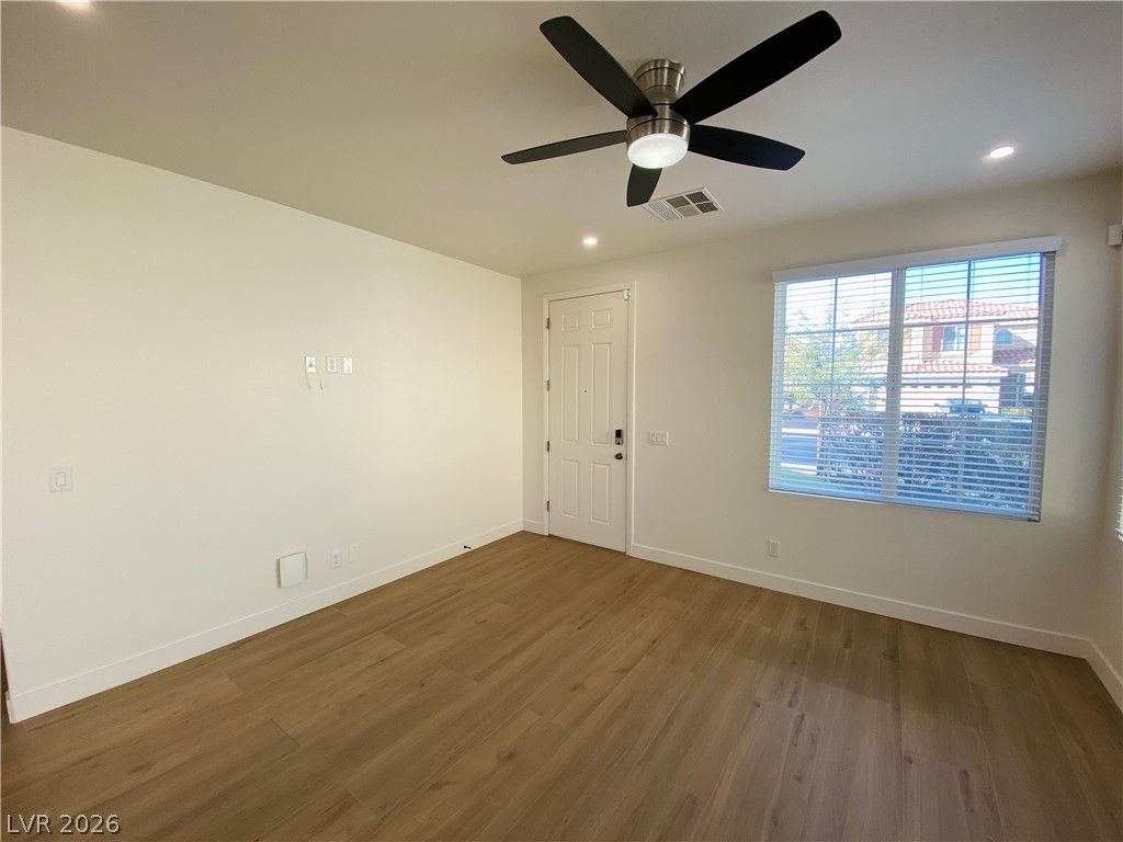 8794 Timber Mesa Street Las Vegas, NV 89139 - Photo 2 of 26 This airy room features durable flooring and ample natural light, ideal for versatile living.