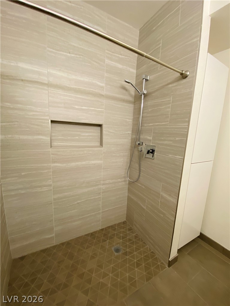 8794 Timber Mesa Street Las Vegas, NV 89139 - Photo 22 of 26 This sleek shower features modern tiling and a functional design, providing a refreshing bathing space.