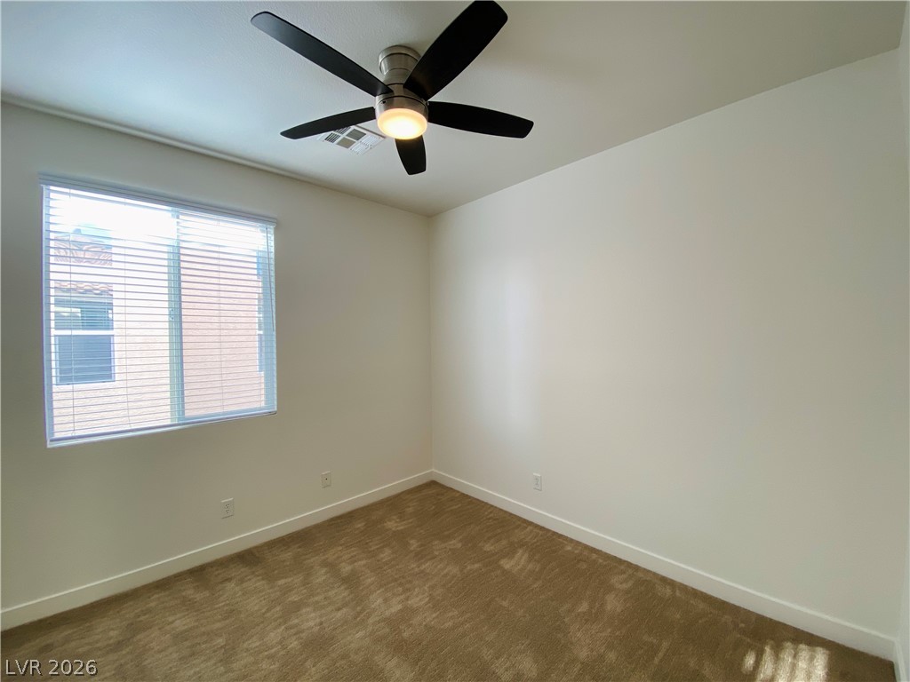 8794 Timber Mesa Street Las Vegas, NV 89139 - Photo 24 of 26 This spacious room features a wide window, offering abundant natural light and comfort.