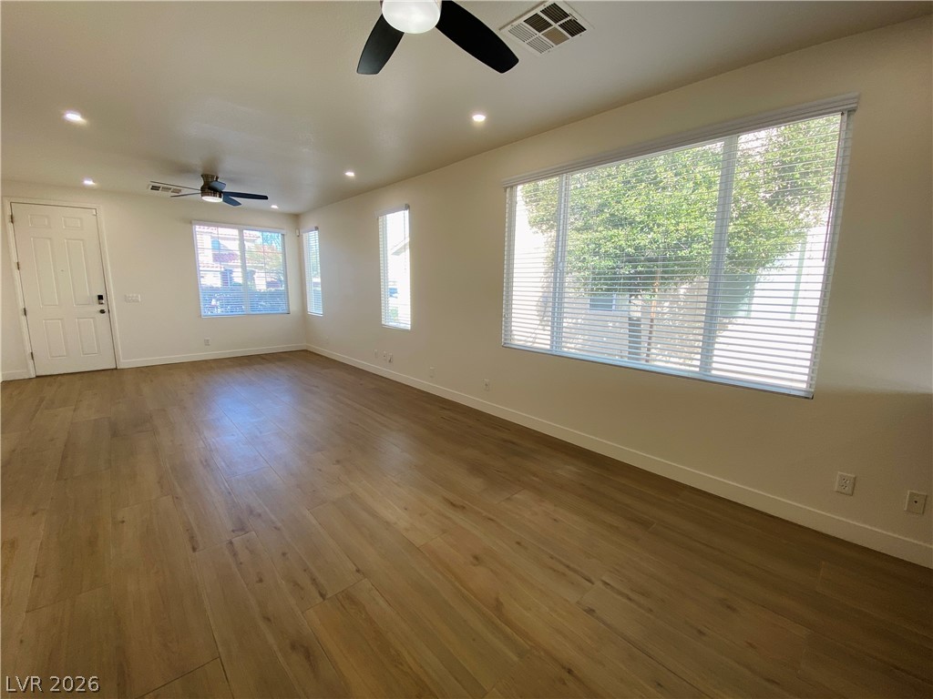 8794 Timber Mesa Street Las Vegas, NV 89139 - Photo 6 of 26 This airy living space features abundant natural light and rich wood flooring.