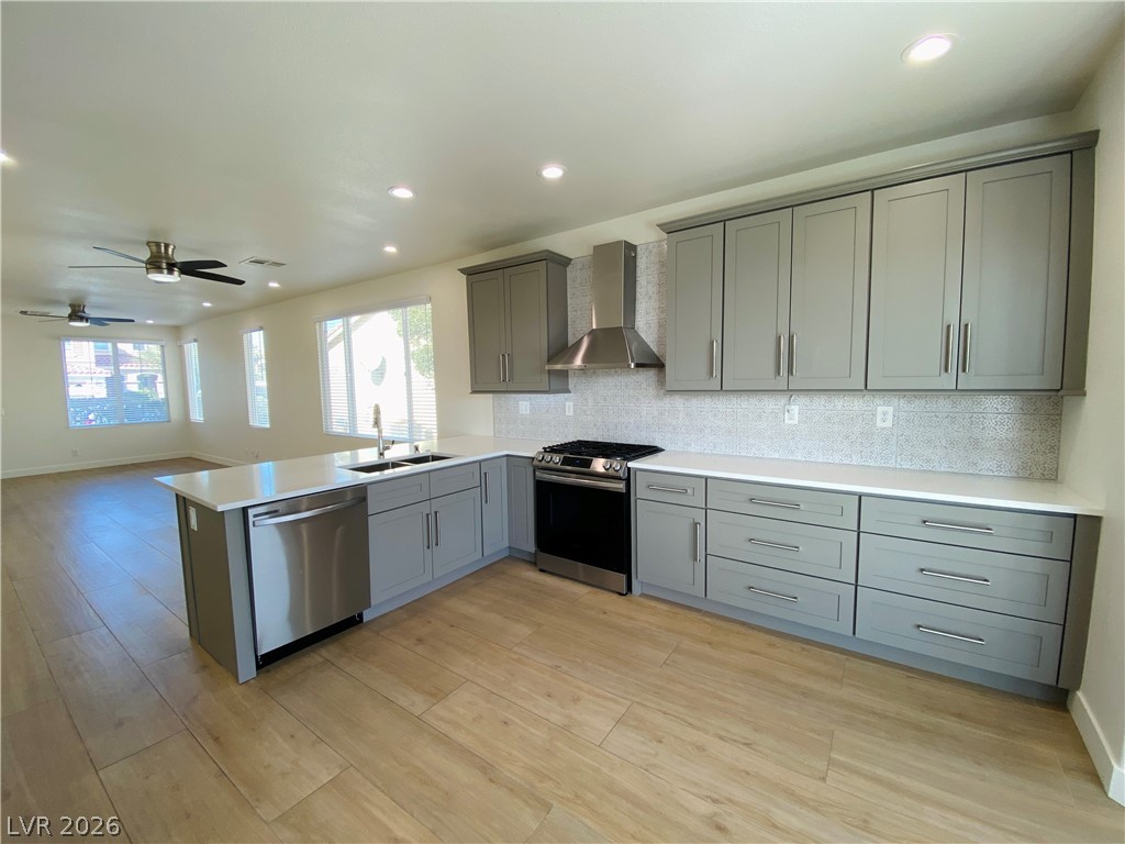8794 Timber Mesa Street Las Vegas, NV 89139 - Photo 7 of 26 Bright and open kitchen flows into the living area, featuring contemporary finishes and practical design.