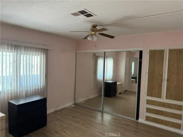 a view of a room with wooden floor and windows